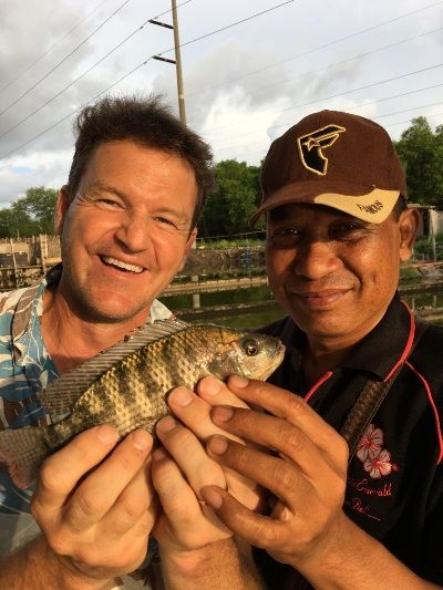 Our driver Agung Wana and I fishing at the bizarre fish farm in the middle of suburbia