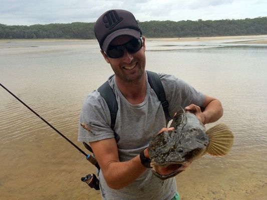 Liam Curtis shows how to safely support a 92cm flathead from Lake Conjola