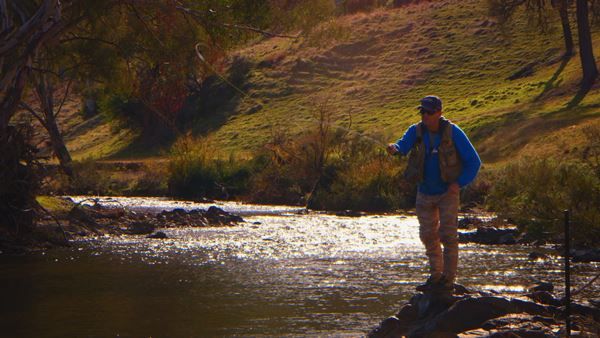 Rob Fly Fishing outside Elms Cottage